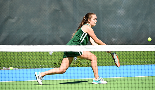 women hitting tennis ball